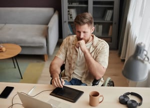 man-with-disability-using-pen-tablet-editing-video-2023-12-29-00-30-10-utc copia